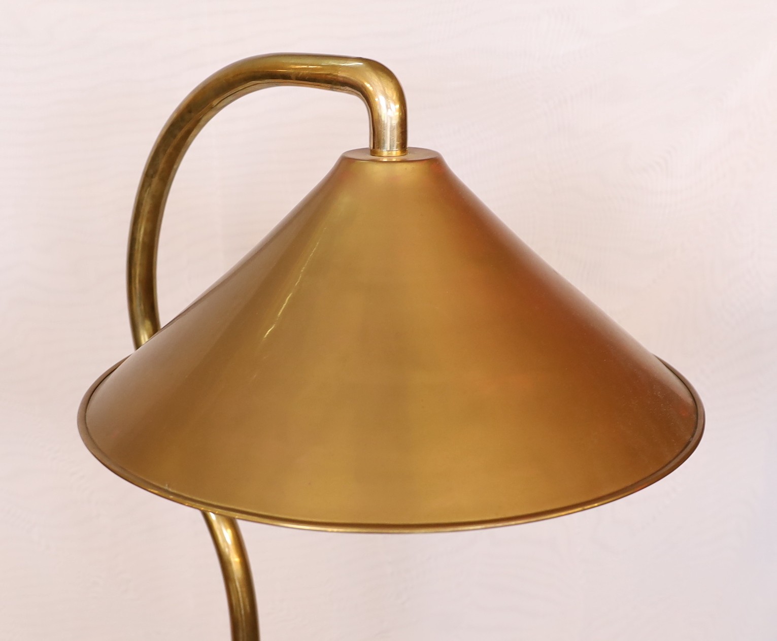A pair of industrial style brass and wrought iron adjustable lamp standards, height 194cm. width of base 62cm